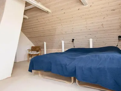 a bedroom with a bed with a wooden ceiling at 10 person holiday home in Harboøre-By Traum in Harboør