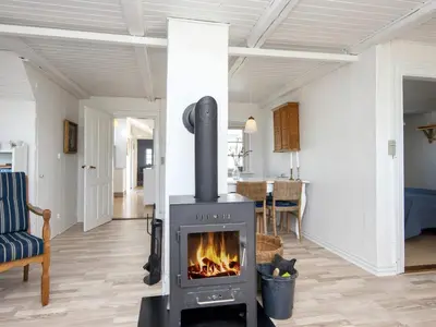 a fireplace in a living room with a stove at 10 person holiday home in Harboøre-By Traum in Harboør