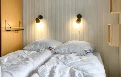 a large white bed with two pillows on it at Awesome Home In Harboøre With Wifi in Harboør