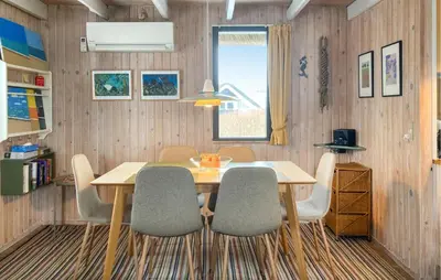 a dining room with a wooden table and chairs at Awesome Home In Harboøre With Wifi in Harboør