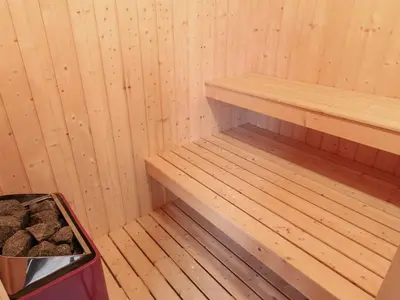 a sauna with wooden shelves and a trash can at Holiday Home Appollina - 400m from the sea by Interhome in Torsted
