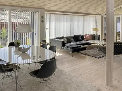 a living room with a glass table and a couch at Holiday Home Telma - 200m from the sea by Interhome in Blokhus