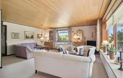 a living room with white furniture and a wooden ceiling at Nice Home In Bækmarksbro With Wifi in Bækmarksbro