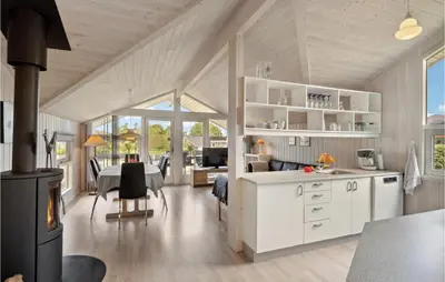 a kitchen and a living room with a stove at 3 Bedroom Gorgeous Home In Farsø in Farsø