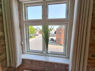 a window with a vase with a plant in it at Skovsgård Hotel in Brovst