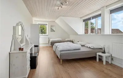 a white bedroom with two beds and a mirror at Beautiful Home In Farsø With Kitchen in Farsø