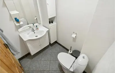a bathroom with a white toilet and a sink at Beautiful Home In Farsø With Kitchen in Farsø