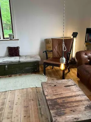 a living room with a couch and a chair at The Old Soap House - stylish and close to beach in Vang