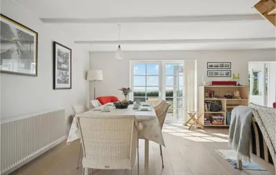 a kitchen and dining room with a table and chairs at Amazing Home In Vesløs in Øsløs