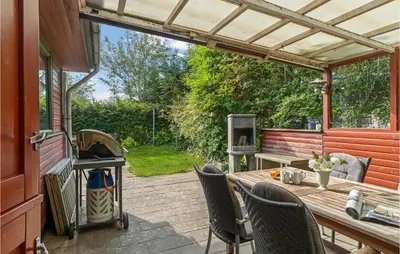 a patio with a table and chairs and a grill at Beautiful Home In Struer With Kitchen in Struer