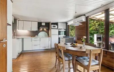 a kitchen and dining room with a table and chairs at Beautiful Home In Struer With Kitchen in Struer