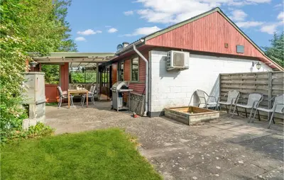 a house with a red roof and a patio at Beautiful Home In Struer With Kitchen in Struer