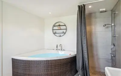 a bathroom with a tub and a shower at Beautiful Home In Thyborøn With Sauna in Thyborøn