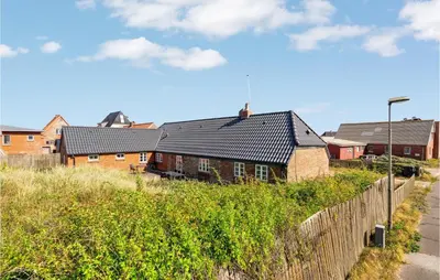 a house on the side of a road at Beautiful Home In Thyborøn With Sauna in Thyborøn