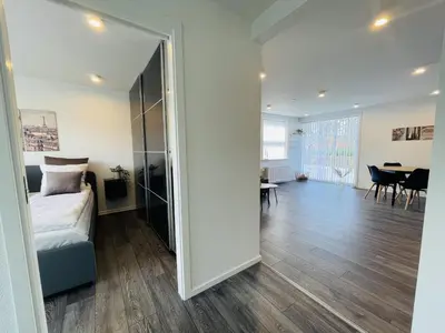 a bedroom with a bed and a living room at aday - Elegant Apartment with Terrace in Svenstrup