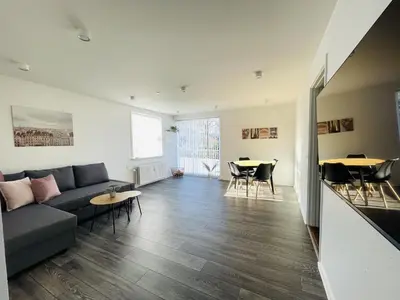 a living room with a couch and a table at aday - Elegant Apartment with Terrace in Svenstrup