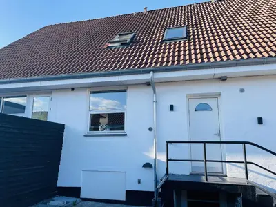 a white house with a red roof at aday - Elegant Apartment with Terrace in Svenstrup