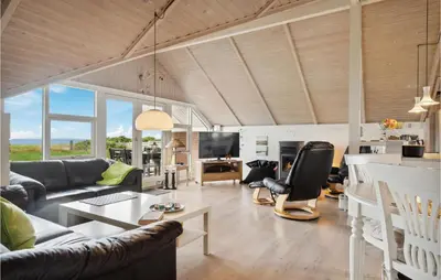 a living room with a couch and a table at 3 Bedroom Cozy Home In Løgstør in Løgsted
