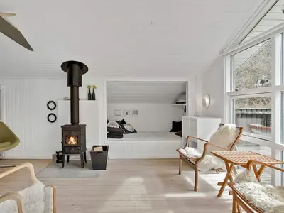 a living room with a bed and a fireplace at 6 person holiday home in Fjerritslev-By Traum in Fjerritslev