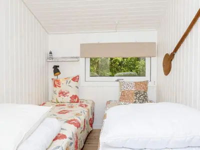 a small room with two beds and a window at 6 person holiday home in Fjerritslev-By Traum in Fjerritslev