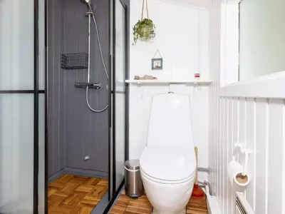 a white toilet in a bathroom with a shower at 6 person holiday home in Fjerritslev-By Traum in Fjerritslev