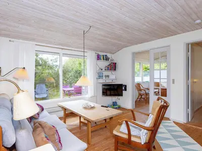 a living room with a couch and a table at 4 person holiday home in Hurup Thy-By Traum in Sønder Ydby