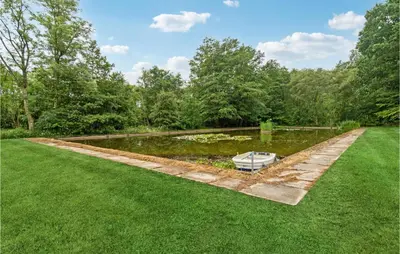 a garden with a pond in the middle of a yard at Cozy Home In Brovst With Kitchen in Brovst