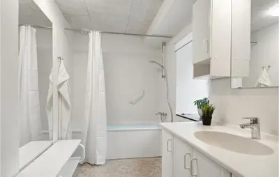 a white bathroom with a sink and a tub at Cozy Home In Brovst With Kitchen in Brovst