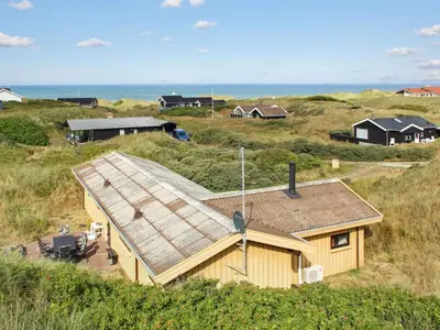 a house on the side of a hill near the ocean at Holiday Home Riitta - 300m from the sea by Interhome in Løkken