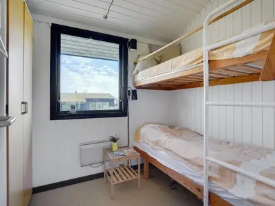 a bedroom with two bunk beds and a window at Holiday Home Ilmari - 190m from the sea by Interhome in Pandrup