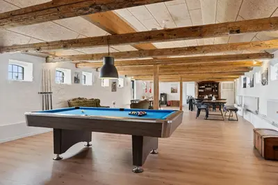 a living room with a pool table in it at Feriehuset Hygge ved Fjorden in Thyholm