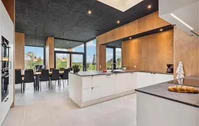 a kitchen with white cabinets and black counter tops at Lovely Home In Højslev With Sauna in Højslev
