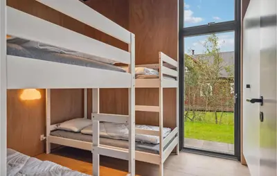 a room with two bunk beds and a window at Lovely Home In Højslev With Sauna in Højslev