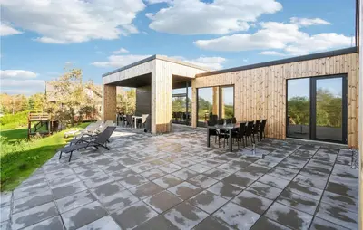 a patio with chairs and a table on top at Lovely Home In Højslev With Sauna in Højslev