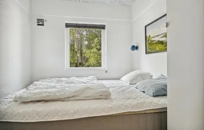 a white bedroom with a large bed with a window at Lovely Home In Hurup Thy in Sønder Ydby