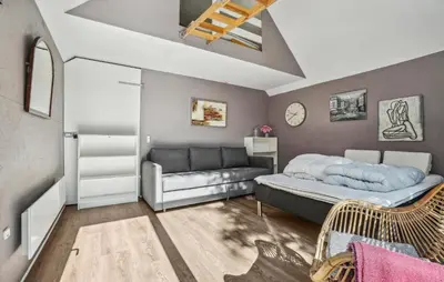 a bedroom with a bed and a couch at Lovely Home In Hurup Thy in Sønder Ydby