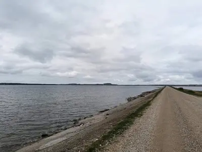 a dirt road next to a large body of water at 6 person holiday home in Thisted-By Traum in Thisted