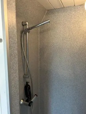 a shower in a bathroom with a shower curtain at Nice holiday home in beautiful resort in Farsø