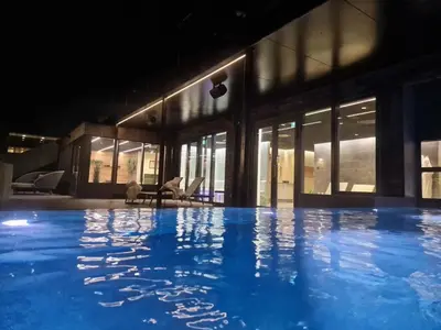 a large swimming pool in front of a building at Nice holiday home in beautiful resort in Farsø