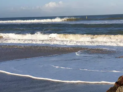 a beach with some waves in the ocean at 8 person holiday home in Fjerritslev-By Traum in Fjerritslev