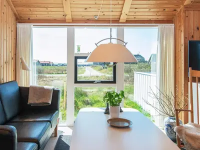 a living room with a table and a couch at 9 person holiday home in Harboøre-By Traum in Harboør
