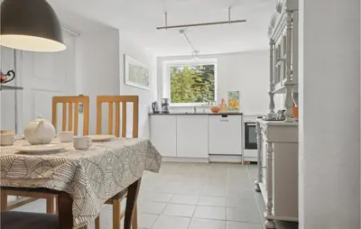 a kitchen with a table with a table cloth on it at Beautiful Apartment In Hurup Thy in Heltborg