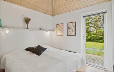 a white bedroom with a bed and a window at 3 Bedroom Lovely Home In Farsø in Farsø