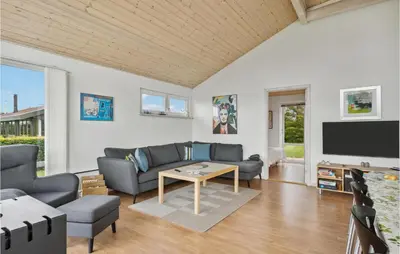a living room with a couch and a tv at 3 Bedroom Lovely Home In Farsø in Farsø
