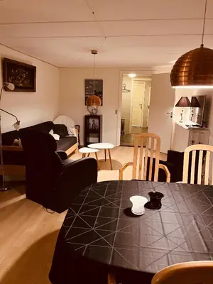 a living room with a table and a couch at Gittes hus in Skive