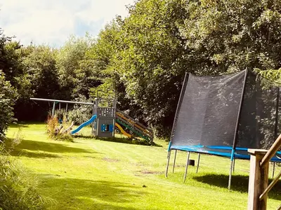 a group of playground equipment in a field at Gittes hus in Skive