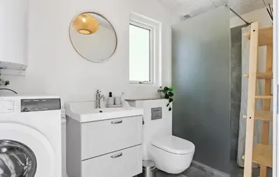a white bathroom with a toilet and a sink at Lovely Home In Højslev With Kitchen in Lundø