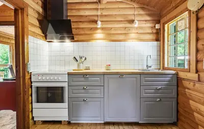 a kitchen with gray cabinets and a stove at Lovely Home In Højslev With Kitchen in Lundø