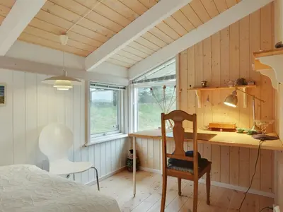 a bedroom with a desk and a chair in a room at Holiday Home Lennja - 300m from the sea by Interhome in Saltum