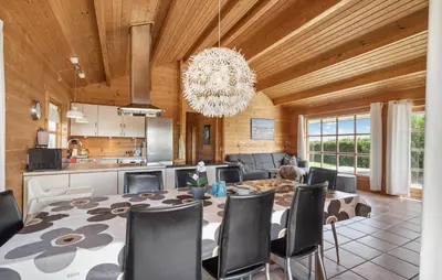 a dining room with a table and a chandelier at Stunning Home In Vinderup With Kitchen in Vinderup